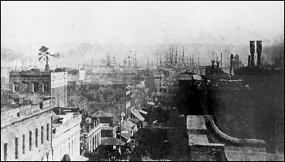 The court was located at 640 Clay Street (left side), San Francisco, from 1874 to 1881. In the background are the masts of ships anchored in the bay.